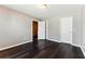 Neutral bedroom featuring hardwood flooring, two entryways, and neutral paint at 5338 Creekview Ln, Morrow, GA 30260