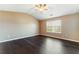 A bedroom featuring a window for natural light and dark wood-look flooring at 5338 Creekview Ln, Morrow, GA 30260