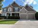 Charming two-story home featuring a manicured front yard, stone accents, and a convenient two-car garage at 111 Edgewater Trl, Canton, GA 30115