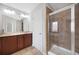 Bright bathroom featuring a double sink vanity and a tiled walk-in shower with glass door at 2308 Oakton Se Pl, Smyrna, GA 30082