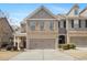 Charming two-story townhome featuring a brick facade and an attached two-car garage at 2308 Oakton Se Pl, Smyrna, GA 30082