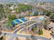 Aerial view showcases tennis courts, a pool, and lake access, all within a desirable community at 3070 Corsair Curv, Cumming, GA 30040