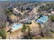 Aerial view of lakefront community with a pool, clubhouse, and tennis courts at 3070 Corsair Curv, Cumming, GA 30040