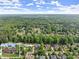 Stunning aerial view of a neighborhood surrounded by lush trees, highlighting the community's serene setting at 3070 Corsair Curv, Cumming, GA 30040
