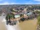 Stunning aerial view displays tennis courts, a pool, a pier, lake access, and beautiful neighborhood homes at 3070 Corsair Curv, Cumming, GA 30040