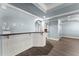 Finished basement wet bar with white wainscoting, granite countertops, and modern flooring at 3070 Corsair Curv, Cumming, GA 30040