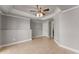 Bedroom with tiled flooring with view into unfinished room and a ceiling fan at 3070 Corsair Curv, Cumming, GA 30040