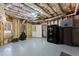 Unfinished basement has exposed beams and concrete walls, with storage cabinets along wall at 3070 Corsair Curv, Cumming, GA 30040