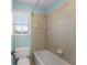 Bathroom with a window and tiled shower and bathtub at 3070 Corsair Curv, Cumming, GA 30040