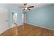 Spacious bedroom featuring an ensuite bathroom, hardwood floors, and ceiling fan at 3070 Corsair Curv, Cumming, GA 30040