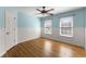 Charming bedroom with hardwood floors, wainscotting, ceiling fan and windows at 3070 Corsair Curv, Cumming, GA 30040