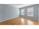 Bright bedroom features hardwood floors, two windows, and a ceiling fan at 3070 Corsair Curv, Cumming, GA 30040