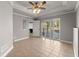 Bedroom boasts neutral tile flooring, ceiling fan, a door to bath, and sliding doors to the pool at 3070 Corsair Curv, Cumming, GA 30040