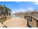 Beautiful wooden dock with still lake view and clear blue sky with light clouds at 3070 Corsair Curv, Cumming, GA 30040