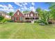 Beautiful brick two-story home with a lush lawn and welcoming front porch at 3070 Corsair Curv, Cumming, GA 30040