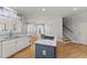 Bright, open kitchen features a blue island, granite countertops, and hardwood floors at 3070 Corsair Curv, Cumming, GA 30040