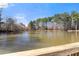 Peaceful lake view with mature trees and foliage reflecting in the still water at 3070 Corsair Curv, Cumming, GA 30040