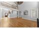 Open living space features hardwood floors, staircase, and large windows for an abundance of natural light at 3070 Corsair Curv, Cumming, GA 30040