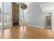 Bright living room with soaring ceilings, beautiful hardwood floors, and a stone fireplace at 3070 Corsair Curv, Cumming, GA 30040