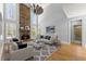 Elegant living room featuring a stone fireplace, high ceilings, and plenty of natural light at 3070 Corsair Curv, Cumming, GA 30040