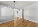 Open living room with hardwood floors and architectural archways create a cozy space at 3070 Corsair Curv, Cumming, GA 30040