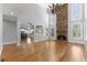 Open living space with stone fireplace, hardwood floors and arched entries to the kitchen at 3070 Corsair Curv, Cumming, GA 30040