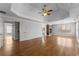 Large main bedroom showcasing a tray ceiling, hardwood floors, and stone fireplace at 3070 Corsair Curv, Cumming, GA 30040