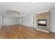 Open main bedroom with tray ceilings, stone fireplace, and hardwood flooring at 3070 Corsair Curv, Cumming, GA 30040