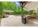 Outdoor kitchen with a built-in grill and bar area with seating, perfect for entertaining at 3070 Corsair Curv, Cumming, GA 30040