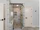 Stylish shower featuring marble tile, river rock flooring and glass door at 3070 Corsair Curv, Cumming, GA 30040