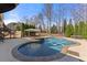 Stunning backyard with pool, spa, and covered seating area, ideal for summer gatherings at 3070 Corsair Curv, Cumming, GA 30040