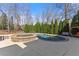 Backyard pool with spa, surrounded by lush greenery, creating a private oasis at 3070 Corsair Curv, Cumming, GA 30040