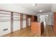 Walk-in closet with custom shelving, drawers, hardwood flooring, and natural light at 3070 Corsair Curv, Cumming, GA 30040