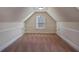 Spacious attic with a window and trim detail along the baseboards at 7347 Moss Stone Dr, Conyers, GA 30094
