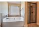 This bathroom boasts a separate tub and shower with tile surround and accent at 7347 Moss Stone Dr, Conyers, GA 30094