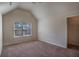 Bright bedroom featuring vaulted ceilings and a large window for natural light at 7347 Moss Stone Dr, Conyers, GA 30094