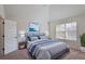 Primary bedroom with tray ceiling, blue decor, and natural light from a window at 7347 Moss Stone Dr, Conyers, GA 30094