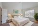 Stylish bedroom features light color palette and vaulted ceilings at 7347 Moss Stone Dr, Conyers, GA 30094