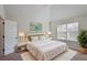 Primary bedroom with tray ceiling, neutral decor, and natural light from a window at 7347 Moss Stone Dr, Conyers, GA 30094