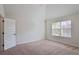 Unfurnished bedroom featuring neutral walls, carpet, a window, and access door at 7347 Moss Stone Dr, Conyers, GA 30094