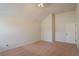 Unfurnished bedroom featuring neutral walls, carpet, a window, and access door at 7347 Moss Stone Dr, Conyers, GA 30094