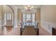 Elegant dining room with bay window, modern chandelier, and seating for six at 7347 Moss Stone Dr, Conyers, GA 30094
