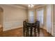 Cozy dining area with a dark wood table and chairs, complemented by a window for natural light at 7347 Moss Stone Dr, Conyers, GA 30094