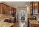 Spacious kitchen featuring granite countertops, stainless steel appliances, and dark wood cabinets at 7347 Moss Stone Dr, Conyers, GA 30094