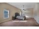 Spacious main bedroom with a comfortable bed, a ceiling fan, and lots of light at 7347 Moss Stone Dr, Conyers, GA 30094