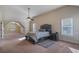 Spacious main bedroom with a comfortable bed, a ceiling fan, and lots of light at 7347 Moss Stone Dr, Conyers, GA 30094