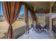 Relaxing covered patio with outdoor seating and curtains, perfect for enjoying the backyard view at 7347 Moss Stone Dr, Conyers, GA 30094