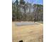 View of the community basketball court surrounded by tall trees at 750 Great Oak Pl, Villa Rica, GA 30180