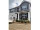 Inviting two-story home boasts rocking-chair front porch, complementary paint colors, and manicured landscaping at 750 Great Oak Pl, Villa Rica, GA 30180