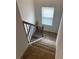 Carpeted staircase with a window and decorative railing at 750 Great Oak Pl, Villa Rica, GA 30180